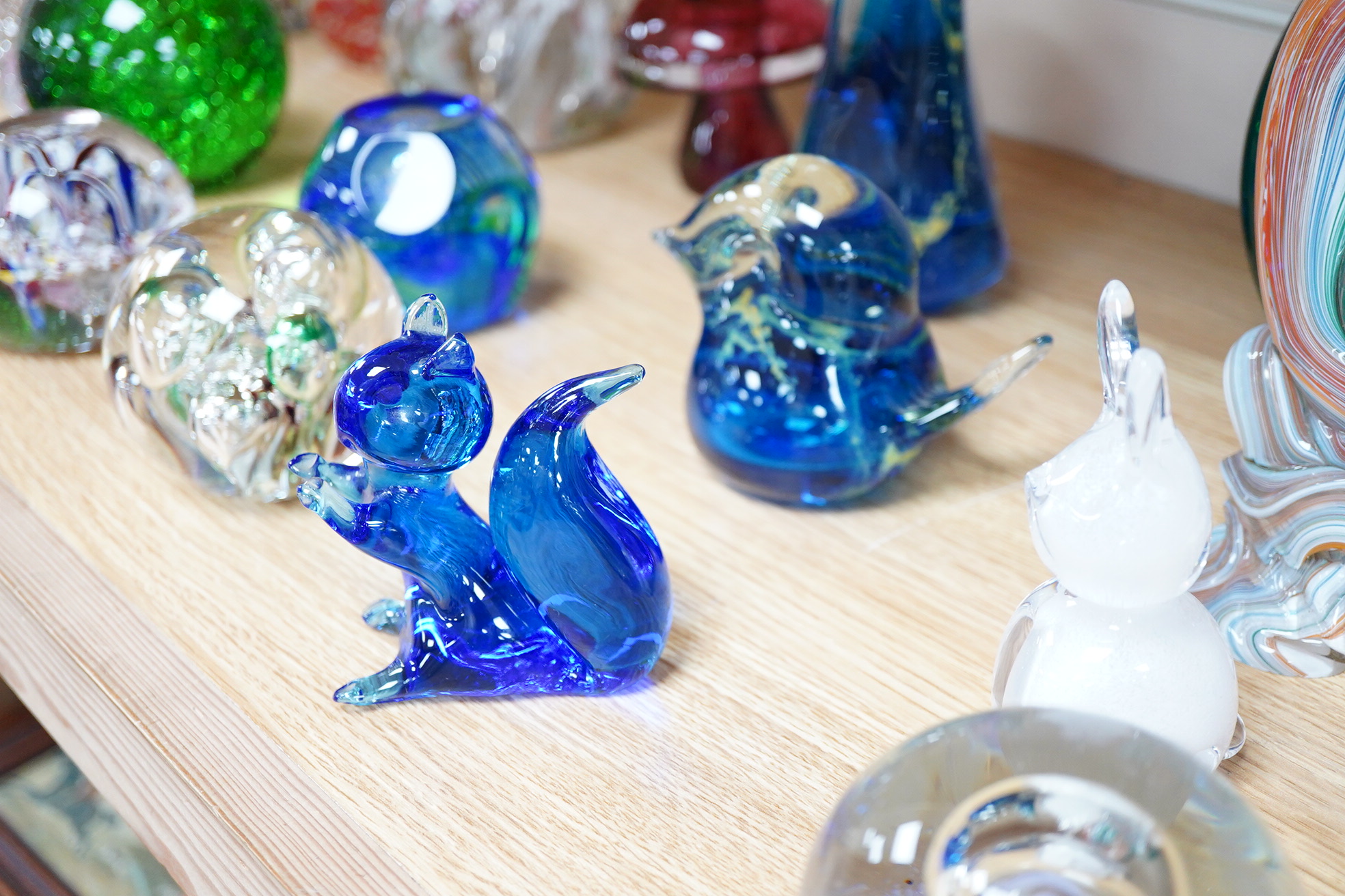 A large collection of 20th century paperweights to include Svaja, Mdina and some novelty examples in the form of animals, largest 27cm high